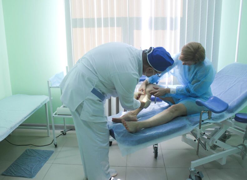 The surgeon examines the patient's veins before performing an operation.
